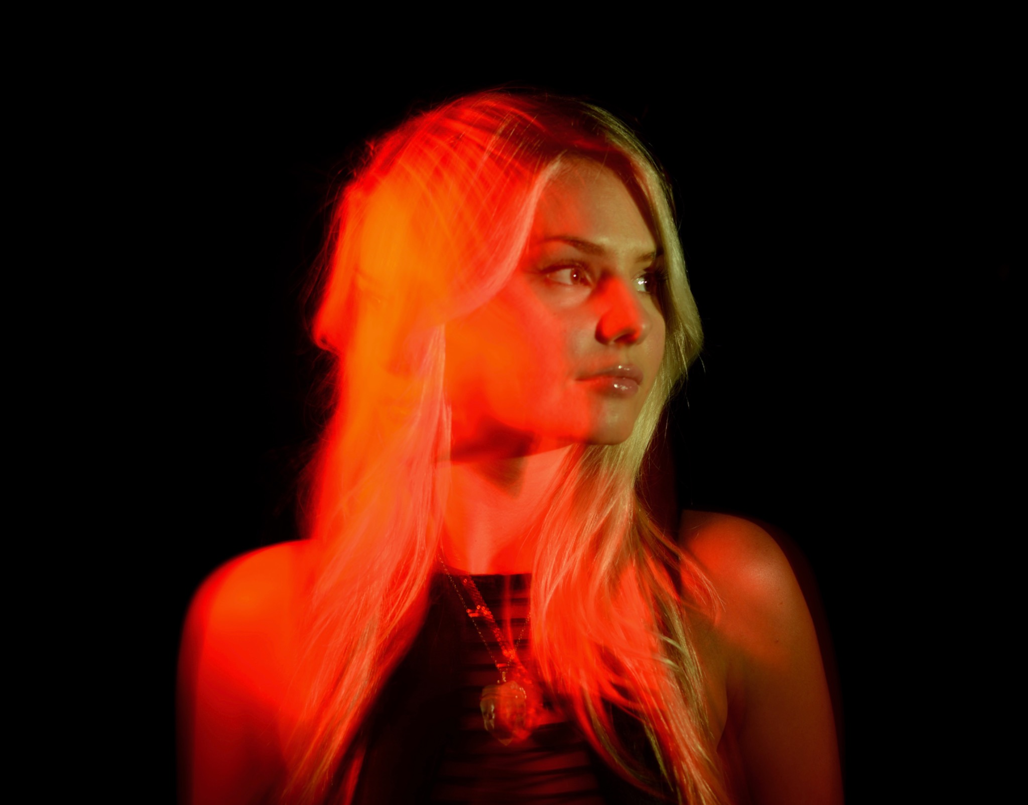 Portrait of Brooke Wolfe lit by warm red light